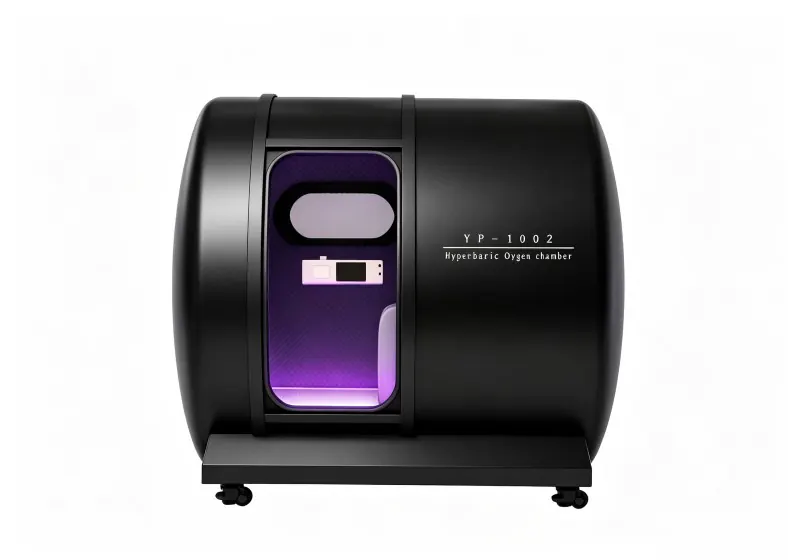 Black hard shell hyperbaric chamber with an oval viewing window, interior control panel and purple lighting.